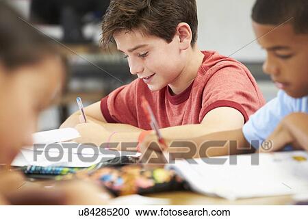 Pupils Studying At Desks In Classroom View Large Photo Image Stock Image - Pupils Studying At Desks In Classroom. Fotosearch