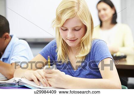 Pupils Studying At Desks In Classroom View Large Photo Image Stock Photo - Pupils Studying At Desks In Classroom. Fotosearch