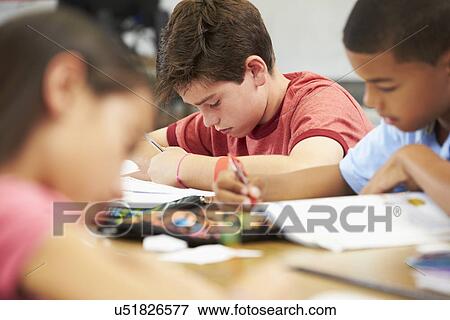 Pupils Studying At Desks In Classroom View Large Photo Image Stock Photo - Pupils Studying At Desks In Classroom. Fotosearch