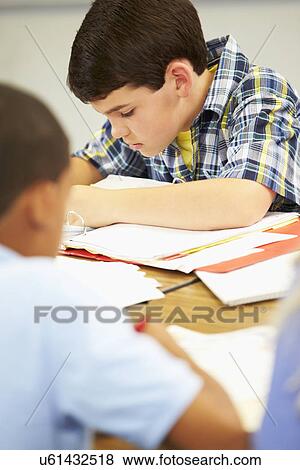 Pupils Studying At Desks In Classroom View Large Photo Image Stock Photo - Pupils Studying At Desks In Classroom. Fotosearch
