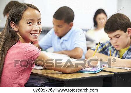 Pupils Studying At Desks In Classroom View Large Photo Image Stock Photo - Pupils Studying At Desks In Classroom. Fotosearch