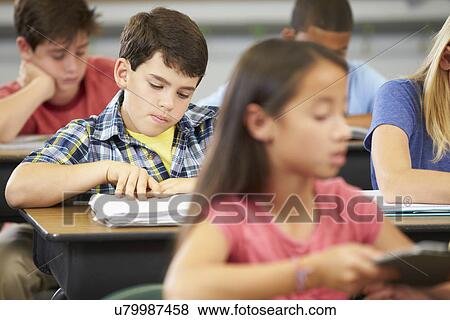 Pupils Studying At Desks In Classroom View Large Photo Image Stock Photo - Pupils Studying At Desks In Classroom. Fotosearch