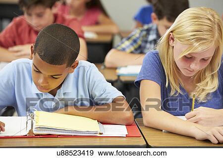 Pupils Studying At Desks In Classroom View Large Photo Image Stock Photo - Pupils Studying At Desks In Classroom. Fotosearch