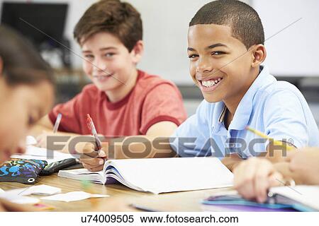 Pupils Studying At Desks In Classroom View Large Photo Image Stock Photography - Pupils Studying At Desks In Classroom. Fotosearch