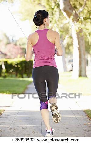 Rear View Of Female Runner Exercising On Suburban Street View Large Photo Image Stock Image - Rear View Of Female Runner Exercising On Suburban Street. Fotosearch