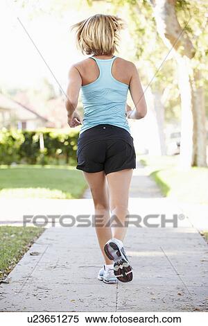 Rear View Of Female Runner Exercising On Suburban Street View Large Photo Image Stock Photography - Rear View Of Female Runner Exercising On Suburban Street. Fotosearch