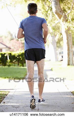 Rear View Of Male Runner Exercising On Suburban Street View Large Photo Image Stock Photograph - Rear View Of Male Runner Exercising On Suburban Street. Fotosearch