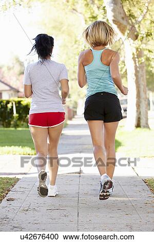 Rear View Of Two Female Runners On Suburban Street View Large Photo Image Stock Image - Rear View Of Two Female Runners On Suburban Street. Fotosearch