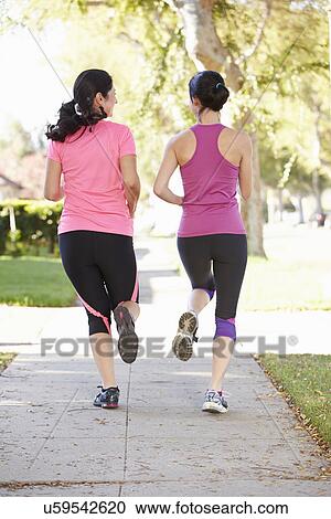 Rear View Of Two Female Runners On Suburban Street View Large Photo Image Stock Image - Rear View Of Two Female Runners On Suburban Street. Fotosearch