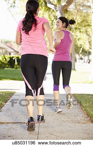 Rear View Of Two Female Runners On Suburban Street View Large Photo Image Stock Photograph - Rear View Of Two Female Runners On Suburban Street. Fotosearch