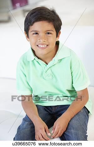 Smiling Boy Sitting On Sofa View Large Photo Image Stock Photograph - Smiling Boy Sitting On Sofa. Fotosearch