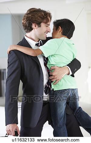 Stock Image - Son Greets Father On Return From Work. Fotosearch