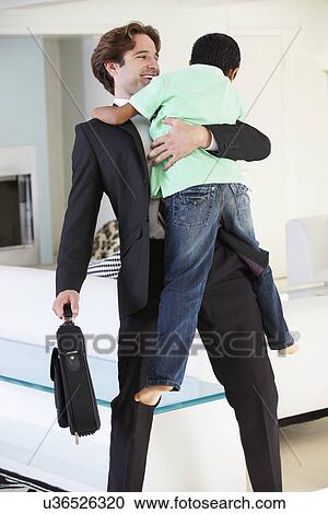 Stock Image - Son Greets Father On Return From Work. Fotosearch