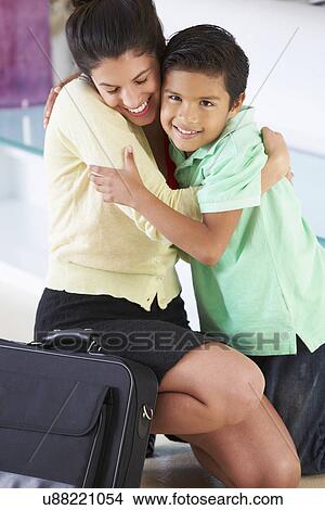 Picture - Son Greets Mother On Return From Work. Fotosearch