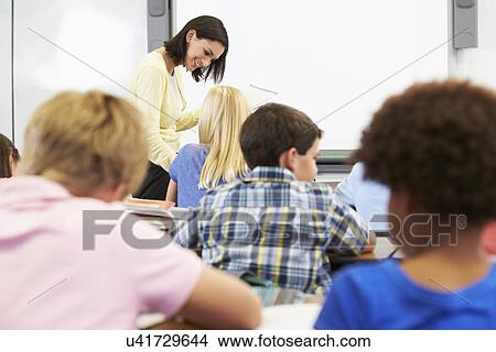 Picture - Teacher Standing In Front Of Class Of Pupils . Fotosearch