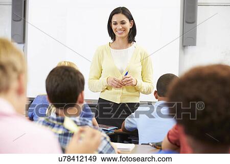 Teacher Standing In Front Of Class Of Pupils View Large Photo Image Stock Photo - Teacher Standing In Front Of Class Of Pupils . Fotosearch