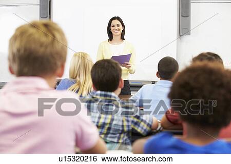 Teacher Standing In Front Of Class Of Pupils View Large Photo Image Stock Photograph - Teacher Standing In Front Of Class Of Pupils . Fotosearch