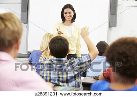 Teacher Standing In Front Of Class Asking Question View Large Photo Image Stock Image - Teacher Standing In Front Of Class Asking Question. Fotosearch