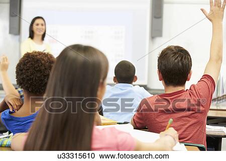 Teacher Standing In Front Of Class Asking Question View Large Photo Image Stock Image - Teacher Standing In Front Of Class Asking Question. Fotosearch