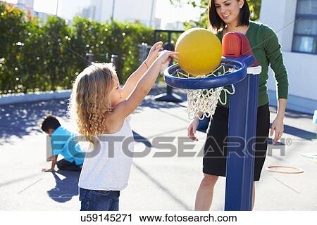 Teacher Supervising Breaktime At Elementary School View Large Photo Image Stock Image - Teacher Supervising Breaktime At Elementary School. Fotosearch