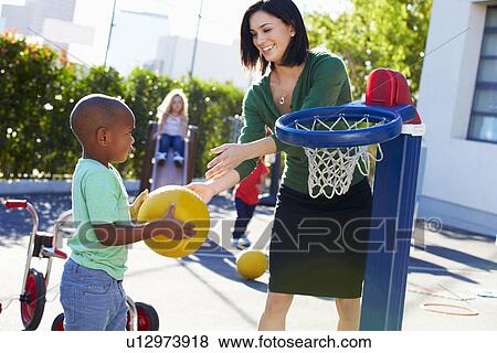 Teacher Supervising Breaktime At Elementary School View Large Photo Image Stock Photo - Teacher Supervising Breaktime At Elementary School. Fotosearch