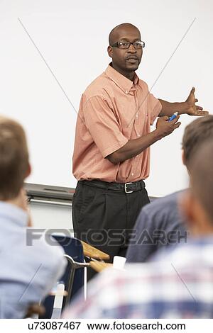 Teacher Talking To Class Standing In Front Of Whiteboard View Large Photo Image Stock Photo - Teacher Talking To Class Standing In Front Of Whiteboard. Fotosearch