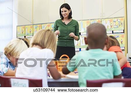 Picture - Teacher Talking To Elementary Pupils In Classroom. Fotosearch
