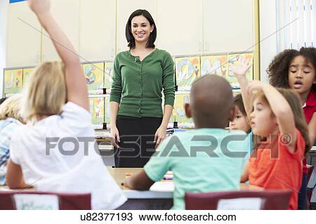 Teacher Talking To Elementary Pupils In Classroom View Large Photo Image Stock Image - Teacher Talking To Elementary Pupils In Classroom. Fotosearch