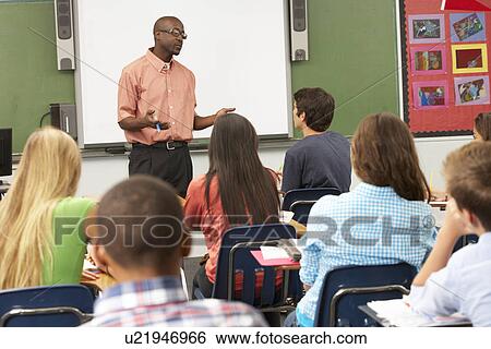 Stock Photograph - Teacher Using Interactive Whiteboard During Lesson. Fotosearch
