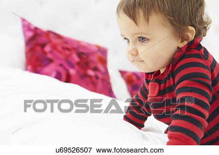 Toddler Crawling On Bed Wearing Pajamas View Large Photo Image Stock Photo - Toddler Crawling On Bed Wearing Pajamas. Fotosearch