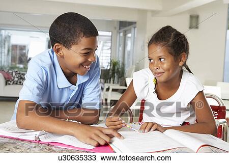Two Children Doing Homework Together In Kitchen View Large Photo Image Stock Image - Two Children Doing Homework Together In Kitchen. Fotosearch
