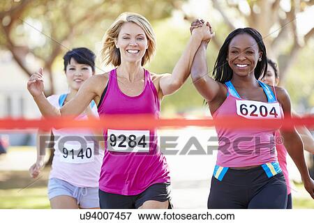 Two Female Runners Finishing Race Together View Large Photo Image Stock Photo - Two Female Runners Finishing Race Together. Fotosearch