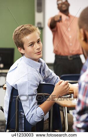 Two Male Pupils Talking In Class View Large Photo Image Stock Image - Two Male Pupils Talking In Class. Fotosearch