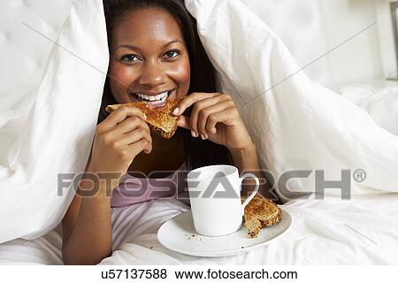 Stock Photo - Woman Enjoying Breakfast In Bed. Fotosearch
