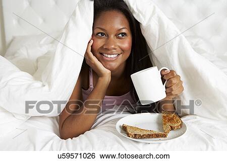 Woman Enjoying Breakfast In Bed View Large Photo Image Stock Photograph - Woman Enjoying Breakfast In Bed. Fotosearch