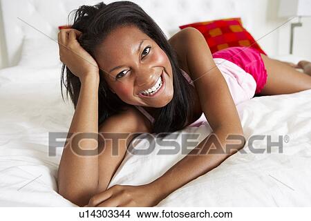 Woman Relaxing In Bed Wearing Pajamas View Large Photo Image Picture - Woman Relaxing In Bed Wearing Pajamas. Fotosearch