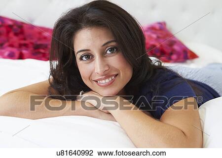 Woman Relaxing In Bed Wearing Pajamas View Large Photo Image Stock Image - Woman Relaxing In Bed Wearing Pajamas. Fotosearch