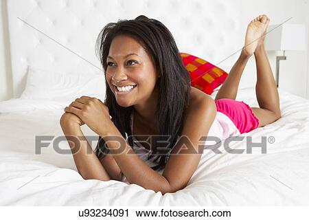 Woman Relaxing In Bed Wearing Pajamas View Large Photo Image Stock Image - Woman Relaxing In Bed Wearing Pajamas. Fotosearch