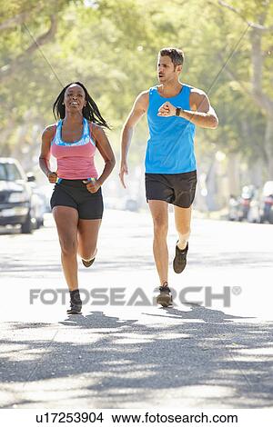 Woman Running Along Street With Personal Trainer View Large Photo Image Picture - Woman Running Along Street With Personal Trainer. Fotosearch