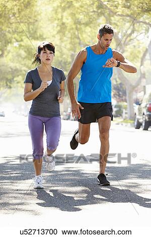 Woman Running Along Street With Personal Trainer View Large Photo Image Stock Image - Woman Running Along Street With Personal Trainer. Fotosearch