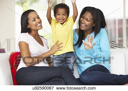Stock Photo - Woman Visiting Pregnant Friend With Son At Home. Fotosearch