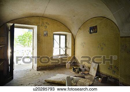 Stock Image - Abandoned kitchen with yellow wallpaper, Albiano d'Ivrea, Italy. Fotosearch