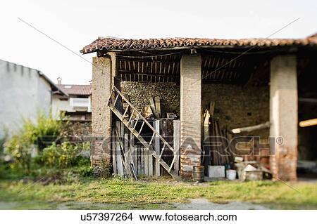 Picture - An abandoned house with ladder and wooden planks in Albiano d'Ivrea, Italy. Fotosearch
