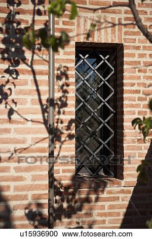 Stock Image - Architectural detail wrought iron grid in front of window; Irvine; California; USA. Fotosearch