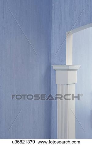 ARCHITECTURAL DETAILS: Sea grass cloth wallpaper with white pilaster casing trim work in Neo-classical fluted design comes 3/4 way up jam, arched doorway, blue View Large Photo Image Stock Photo - ARCHITECTURAL DETAILS: Sea grass cloth wallpaper with white pilaster casing trim work in Neo-classical fluted design comes 3/4 way up jam, arched doorway, blue. Fotosearch