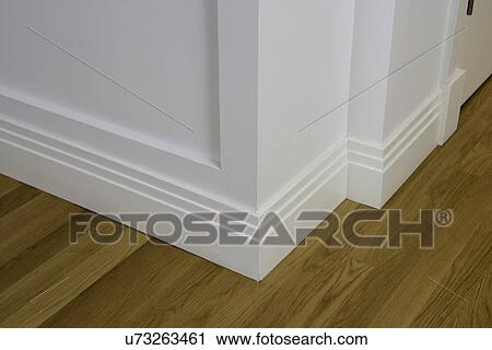 Stock Image - ARCHITECTURAL TRIM: baseboard detail, wood floor, geometric. Fotosearch