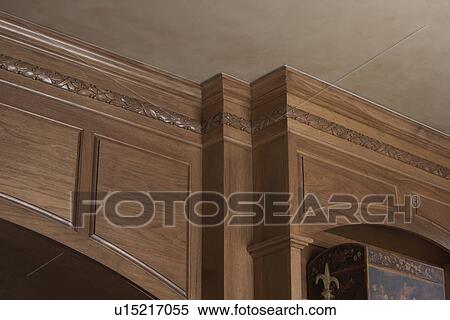 Stock Photography - ARCHITECTURAL TRIM: light stained wood, paneled walls, crown molding. Fotosearch