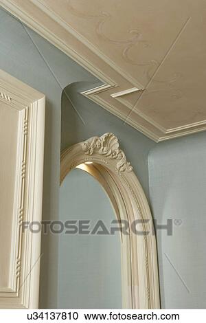 Stock Image - ARCHITECTURAL TRIM: Pale blue, white ornate crown molding and trim. Fotosearch