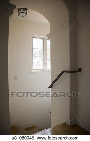 Stock Photography - Archway and railing above wooden staircase; Carpinteria; California; USA. Fotosearch
