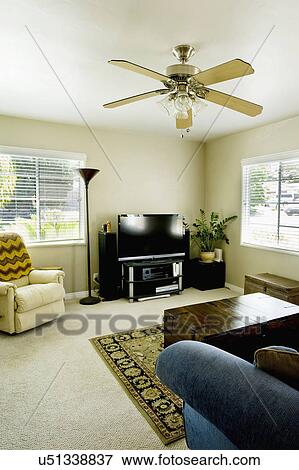 Stock Photo - Armchair and entertainment center in living room, San Diego, California, United States of America. Fotosearch